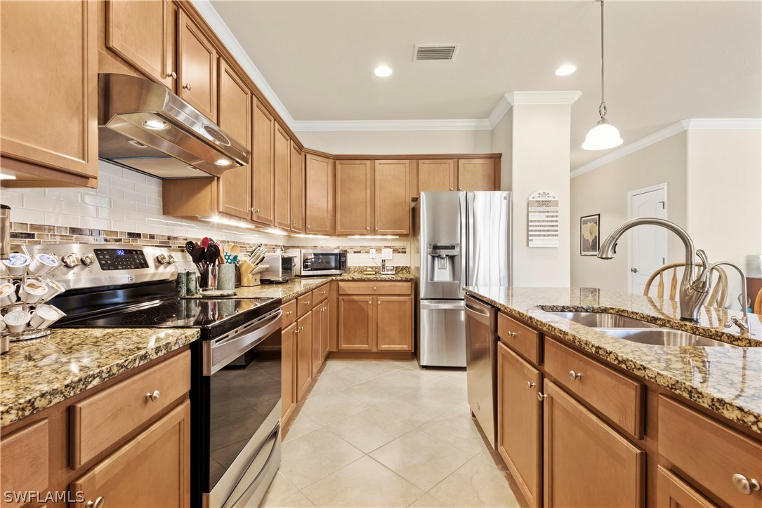 11680 Eros Road Lehigh Acres, FL 33971 - Photo 11 of 27 a kitchen with granite countertop a sink stainless steel appliances and cabinets