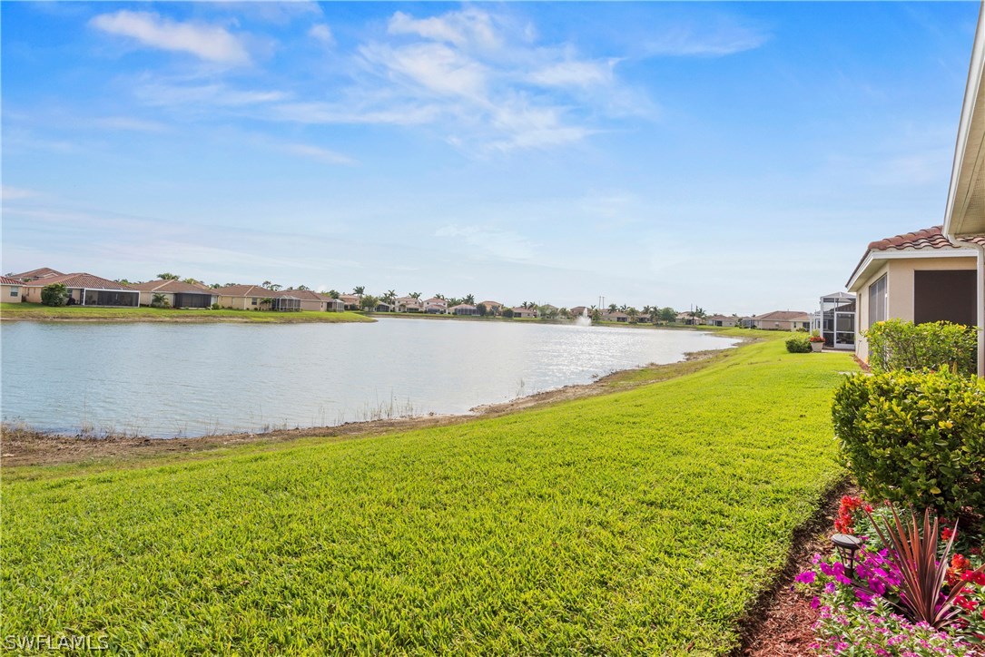 11680 Eros Road Lehigh Acres, FL 33971 - Photo 17 of 27 a view of a lake with a big yard