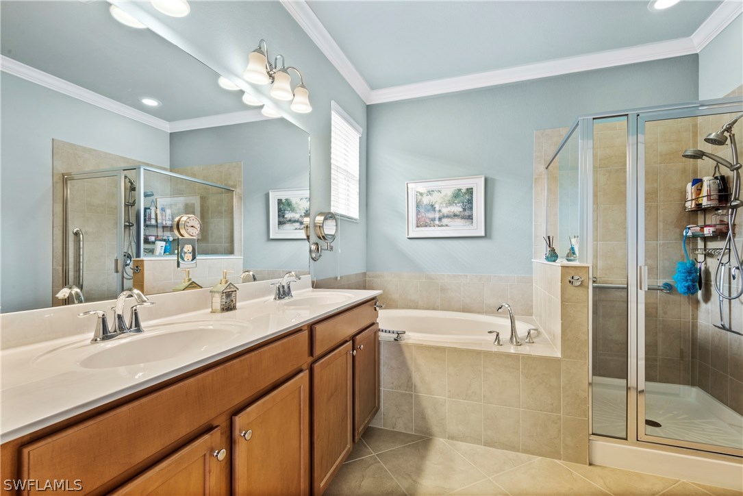 11680 Eros Road Lehigh Acres, FL 33971 - Photo 20 of 27 a bathroom with a tub a sink and mirror