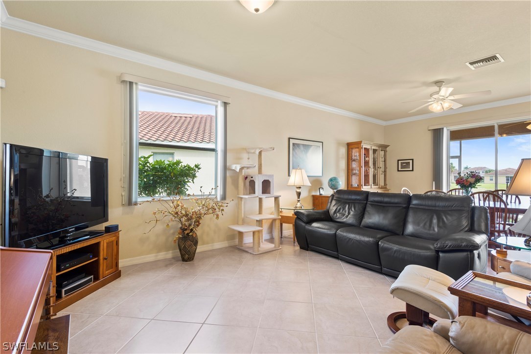 11680 Eros Road Lehigh Acres, FL 33971 - Photo 2 of 27 a living room with furniture and a flat screen tv