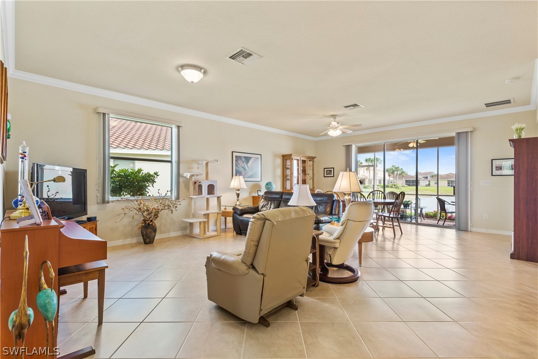 11680 Eros Road Lehigh Acres, FL 33971 - Photo 5 of 27 a living room with furniture and a large window