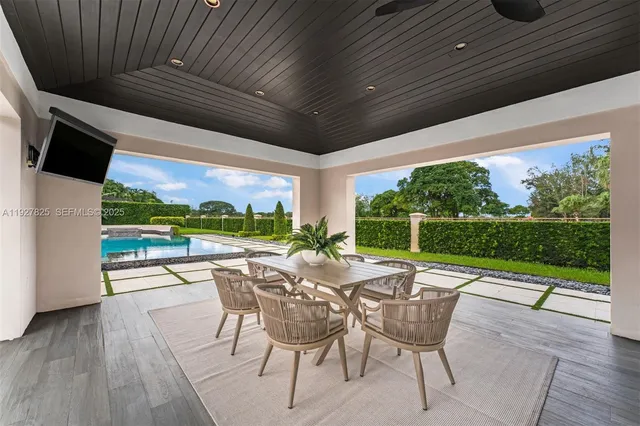 a bedroom with furniture and a large window