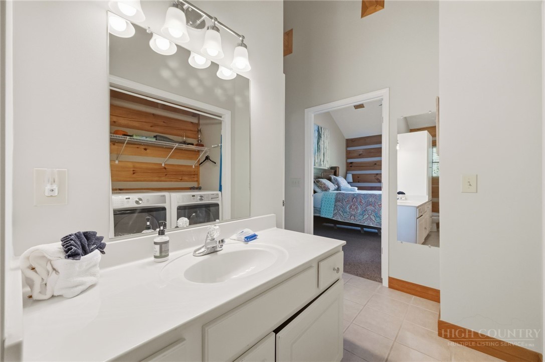 850 River Ridge Road Boone, NC 28607 - Photo 16 of 26 a en suite bathroom with a double vanity sink and a mirror