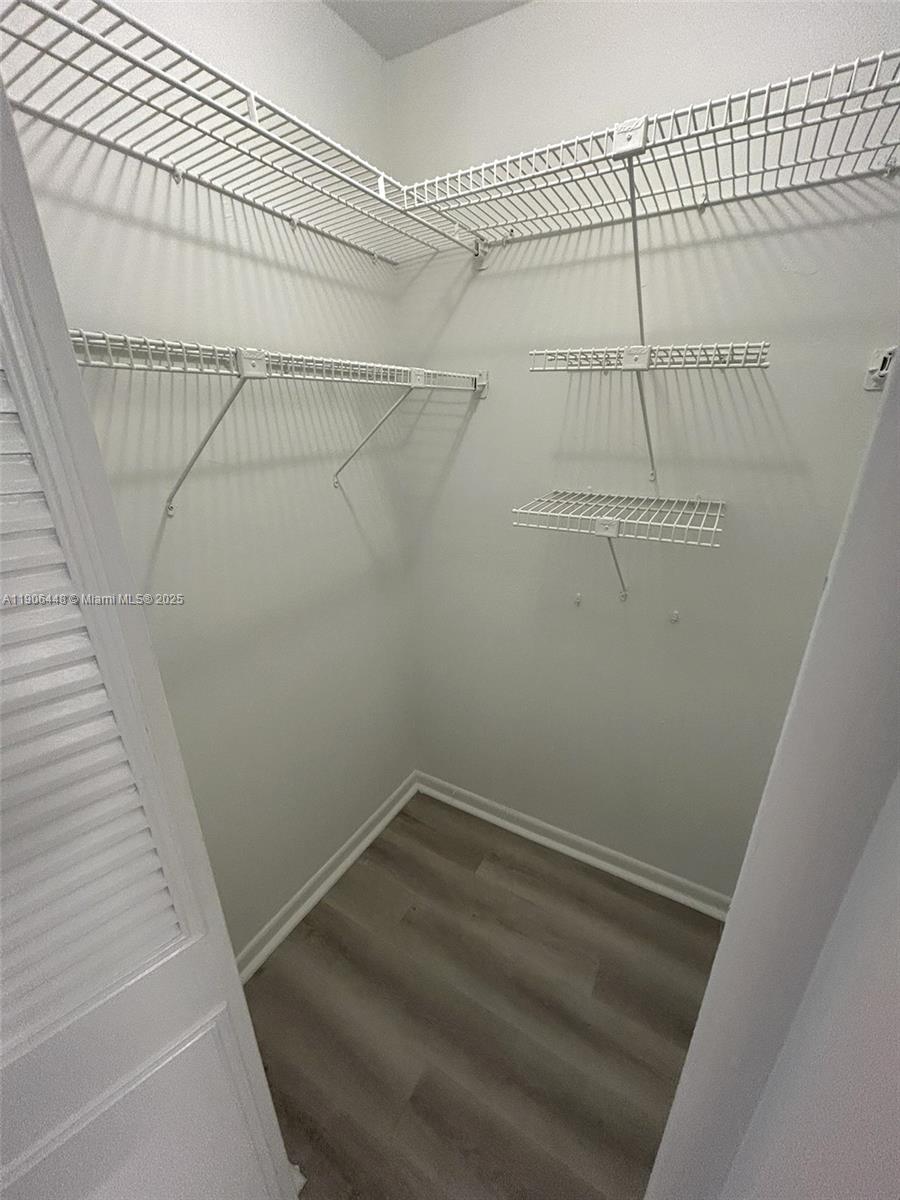 11905 Northeast 2nd Avenue, Unit C402 North Miami, FL 33161 - Photo 12 of 18 a view of a room with racks on the wall