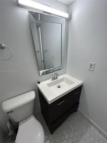 a bathroom with a sink toilet and mirror