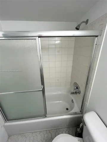 a bathroom with a bathtub and a toilet