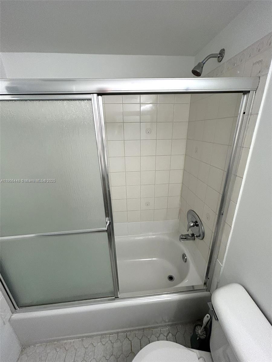 11905 Northeast 2nd Avenue, Unit C402 North Miami, FL 33161 - Photo 15 of 18 a bathroom with a bathtub and a toilet