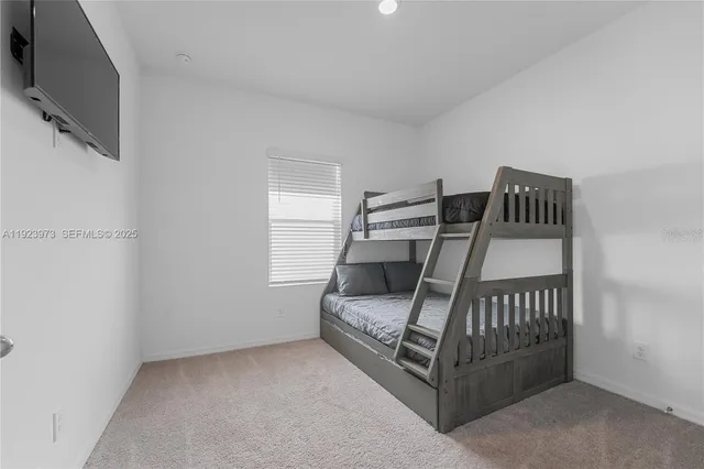 a bedroom with furniture and a flat screen tv
