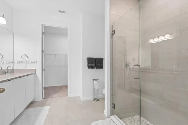 a bathroom with a shower and a sink
