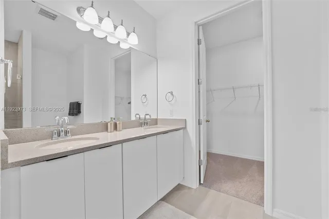 a bathroom with a double vanity sink and a mirror