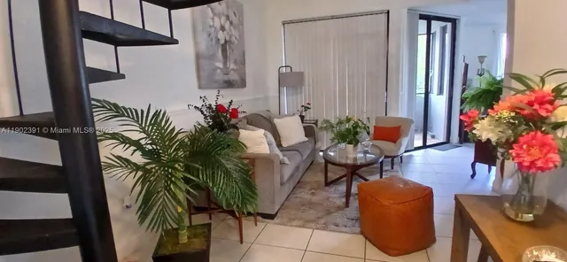 a living room with furniture and flowers