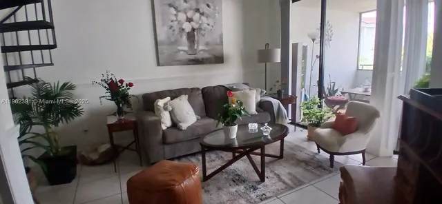 a living room with furniture and a potted plant