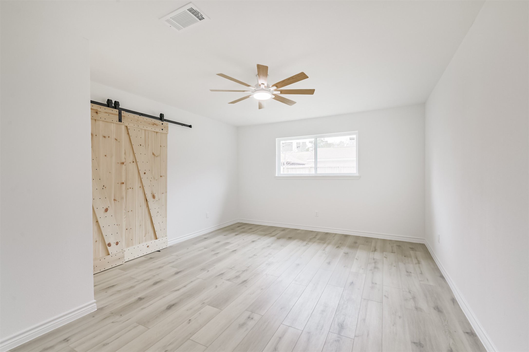 4215 Rosegate Drive Spring, TX 77373 - Photo 19 of 38 The primary bedroom is complemented by a custom barn door the separates the bathroom.