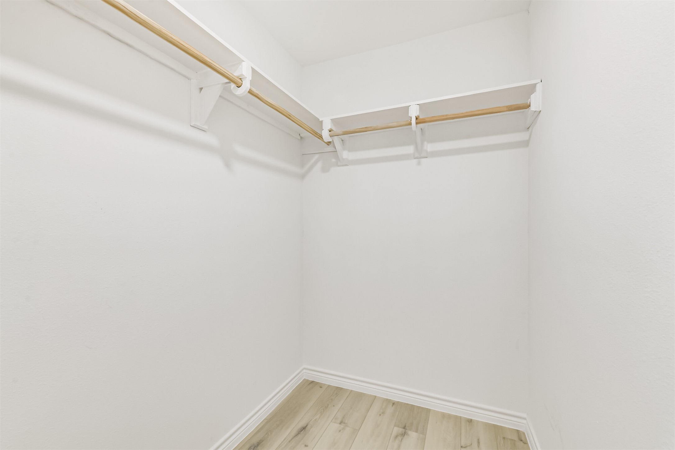 4215 Rosegate Drive Spring, TX 77373 - Photo 24 of 38 This walk-in closet features custom shelf brackets and ample space for your wardrobe.