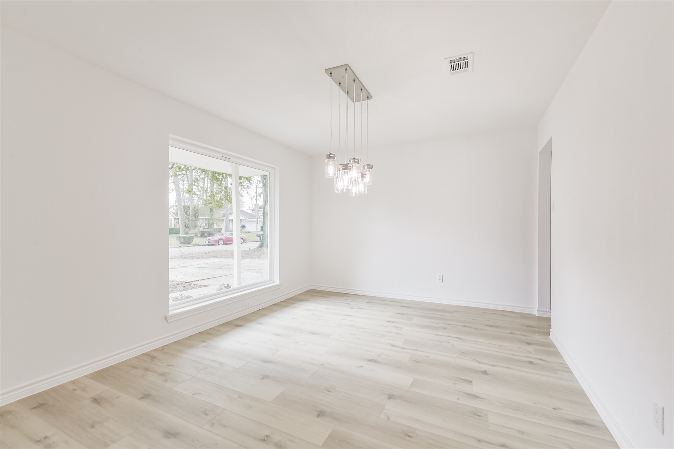 4215 Rosegate Drive Spring, TX 77373 - Photo 5 of 38 The formal dining area floods with natural light from the custom picture window, and features the perfect light fixture.