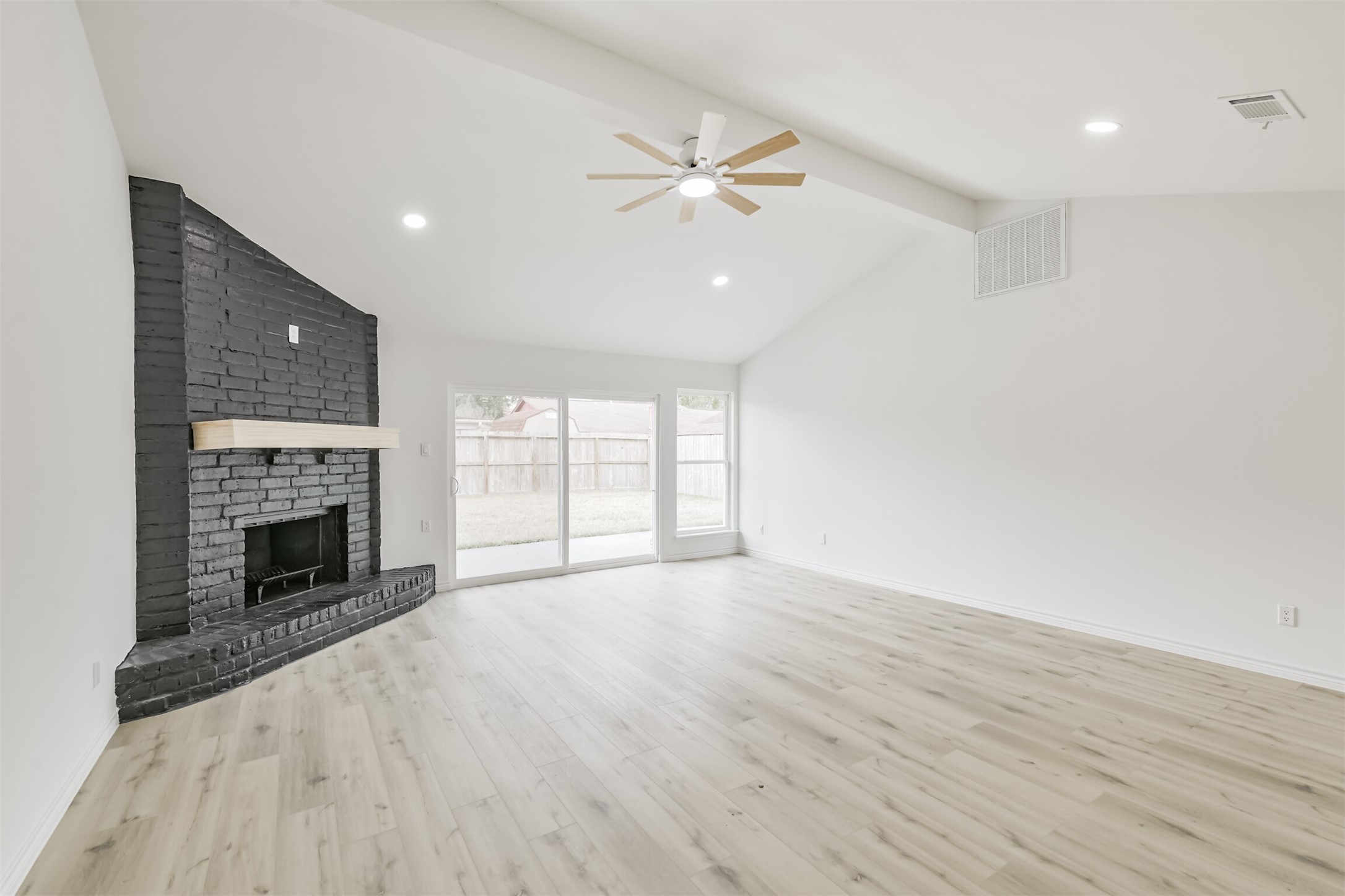 4215 Rosegate Drive Spring, TX 77373 - Photo 9 of 38 The living room features an updated wood burning fireplace, and vaulted ceilings.