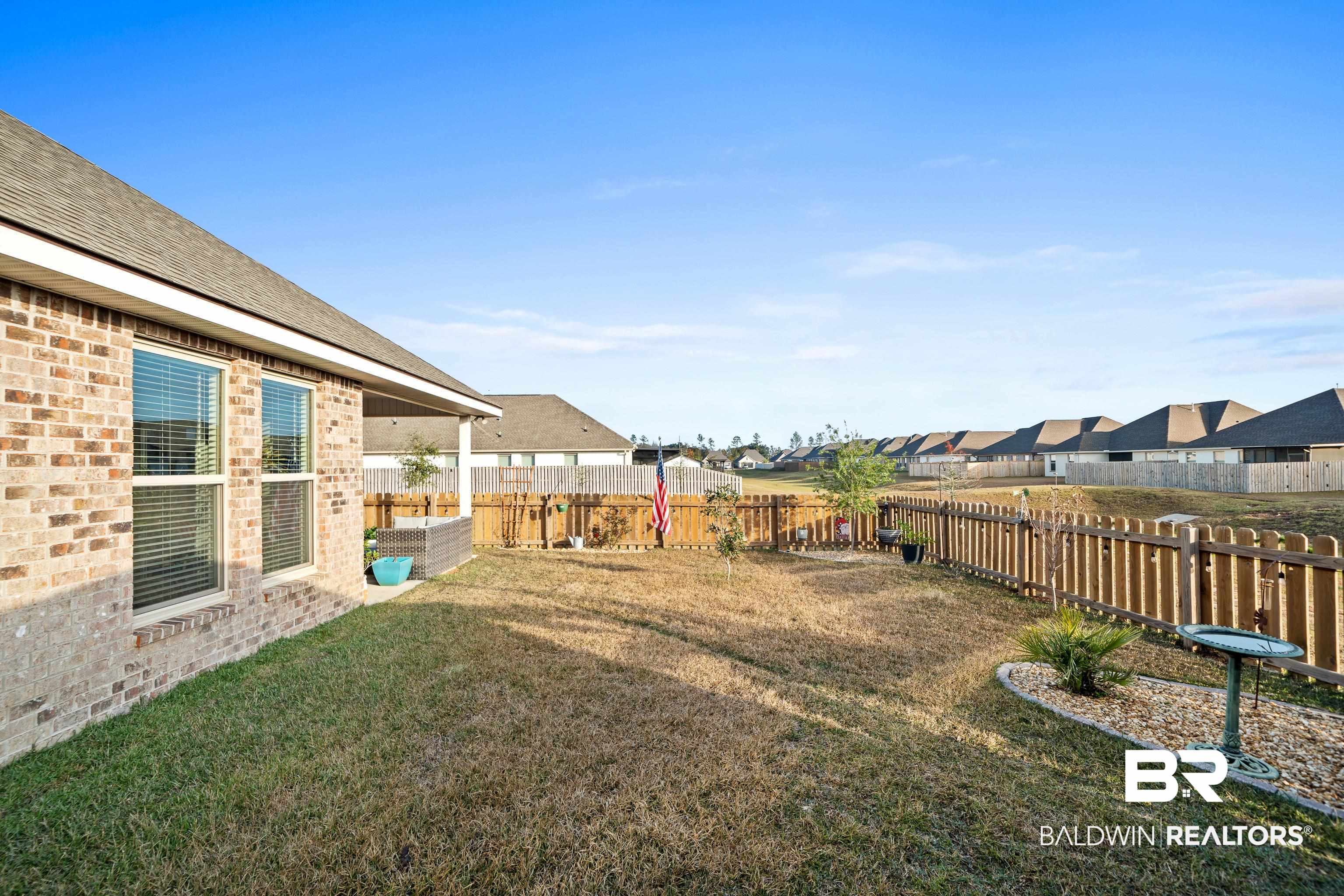 1390 Aldon Street Foley, AL 36535 - Photo 24 of 31 Fenced backyard featuring a residential view and a patio area
