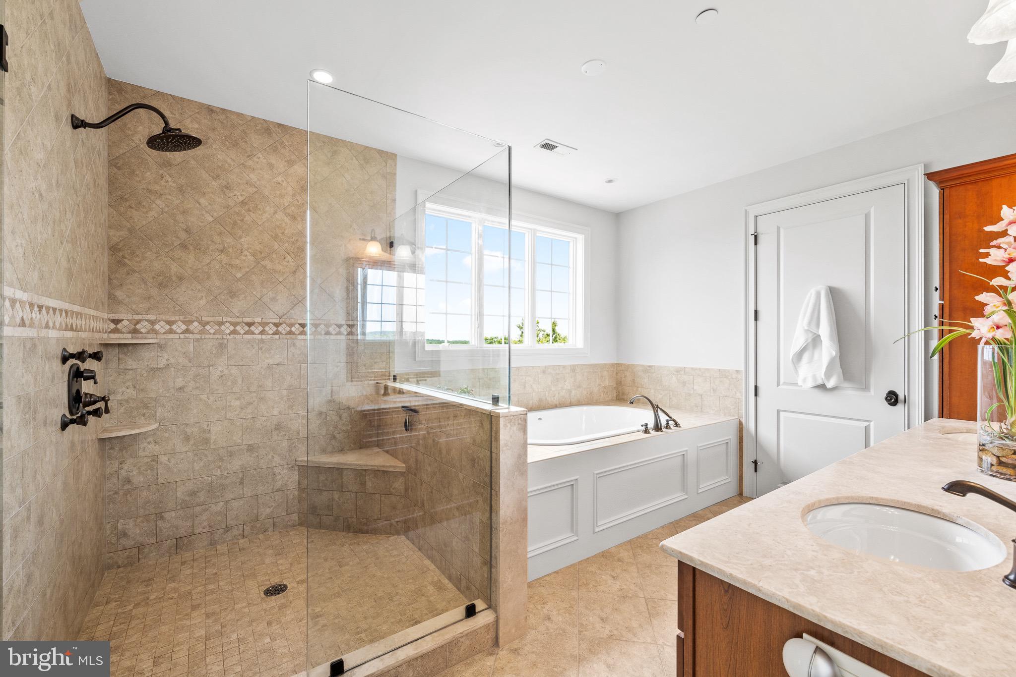 5835 Ridgeview Drive Doylestown, PA 18902 - Photo 44 of 63 a bathroom with a granite countertop sink a mirror a bathtub and next to a window