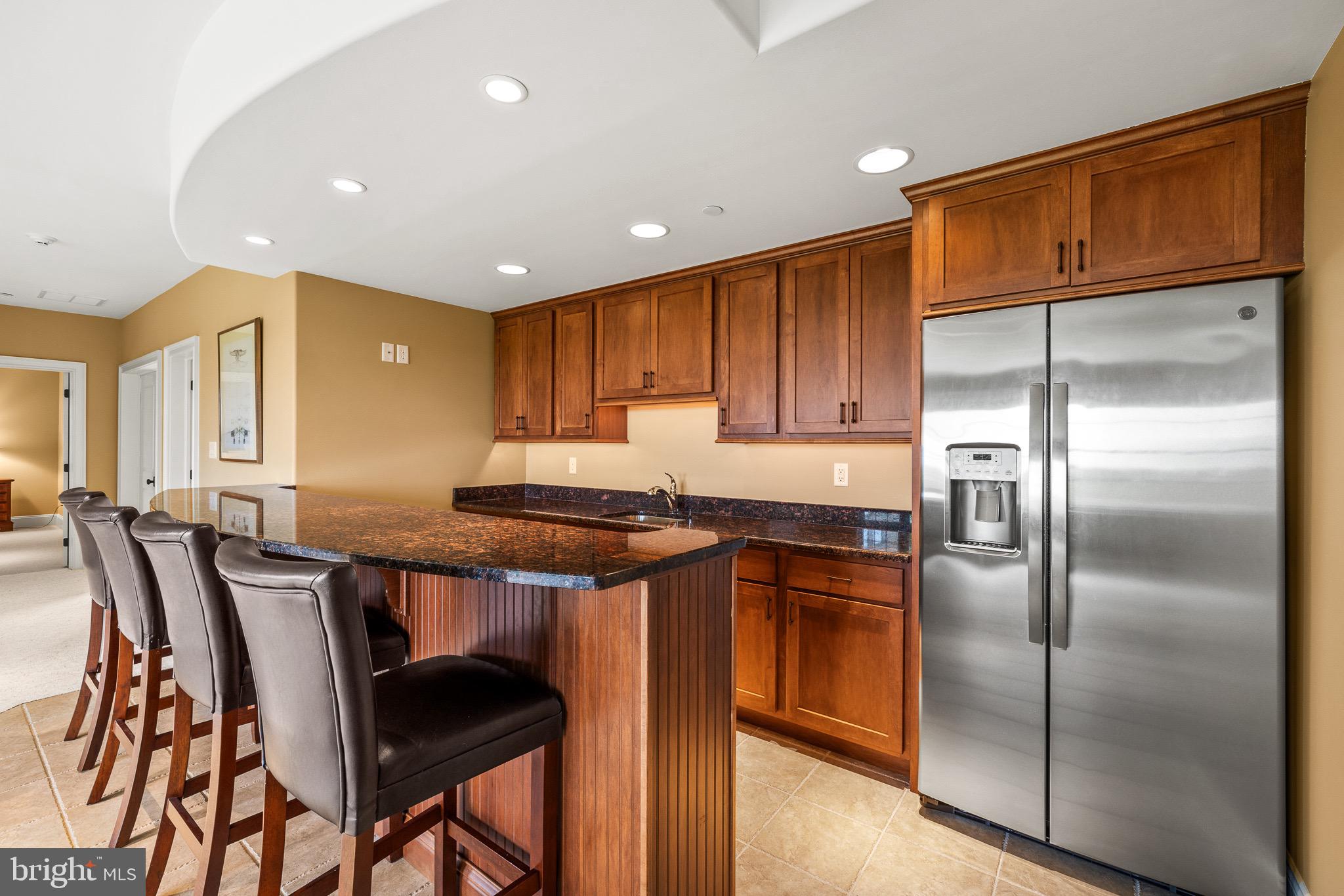 5835 Ridgeview Drive Doylestown, PA 18902 - Photo 52 of 63 a kitchen with stainless steel appliances granite countertop a refrigerator a stove a sink a dining table and chairs with wooden floor