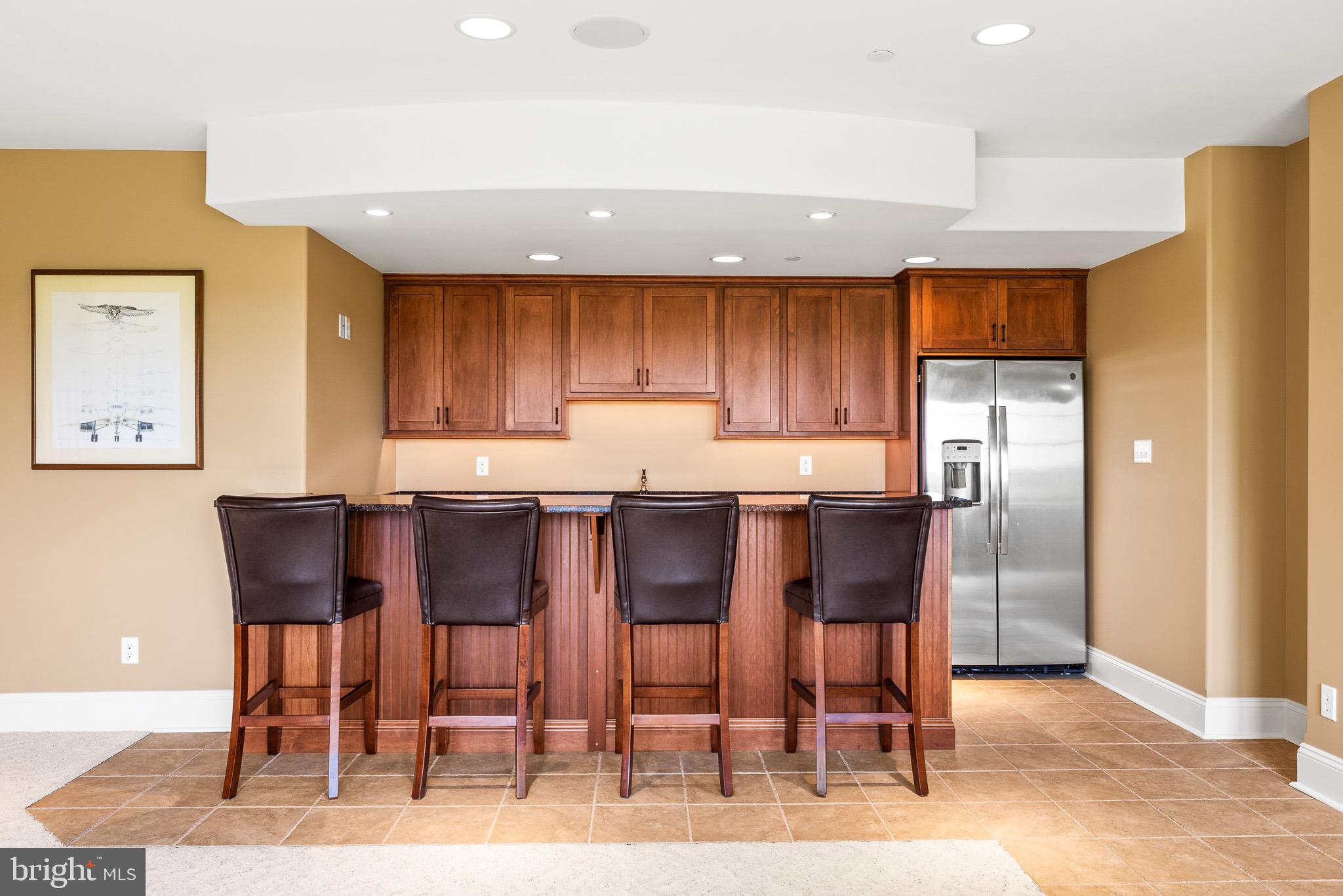 5835 Ridgeview Drive Doylestown, PA 18902 - Photo 53 of 63 a kitchen with granite countertop wooden cabinets and a refrigerator