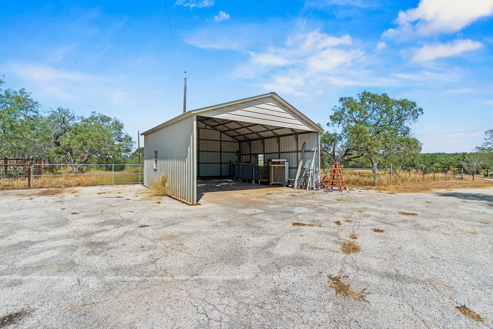 1951 Dowdy Road Seguin, TX 78155 - Photo 29 of 40 A spacious metal carport provides protected parking on a expansive paved driveway.
