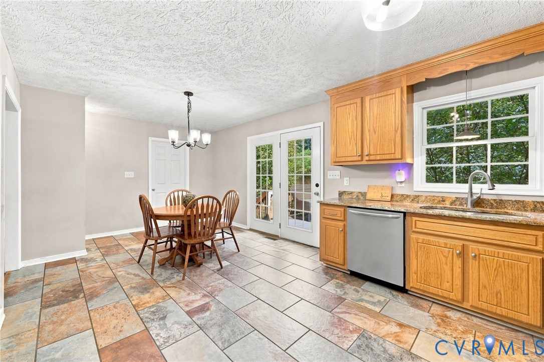 16753 Jolly Road Disputanta, VA 23842 - Photo 25 of 44 Kitchen featuring wood cabinetry, stone countertop