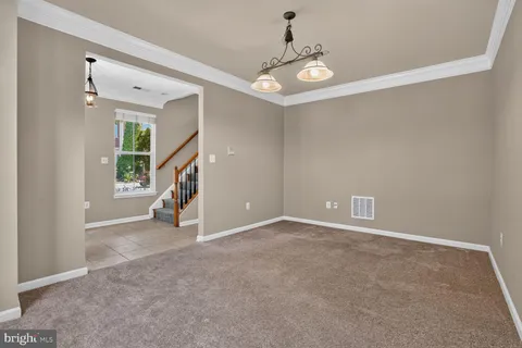 a view of an empty room with stairs