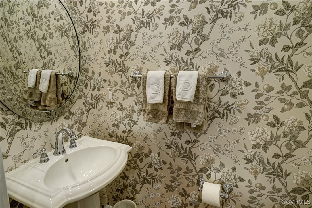 709 Chiswick Park Road Henrico, VA 23229 - Photo 22 of 47 Half bathroom with wallpapered walls and a sink