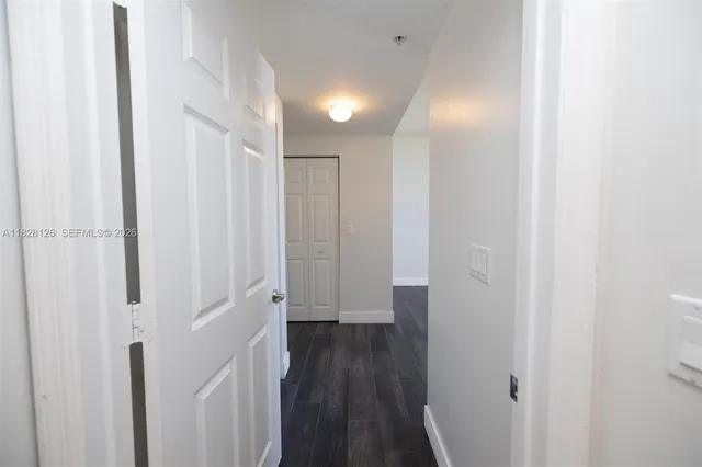a view of a hallway with wooden floor