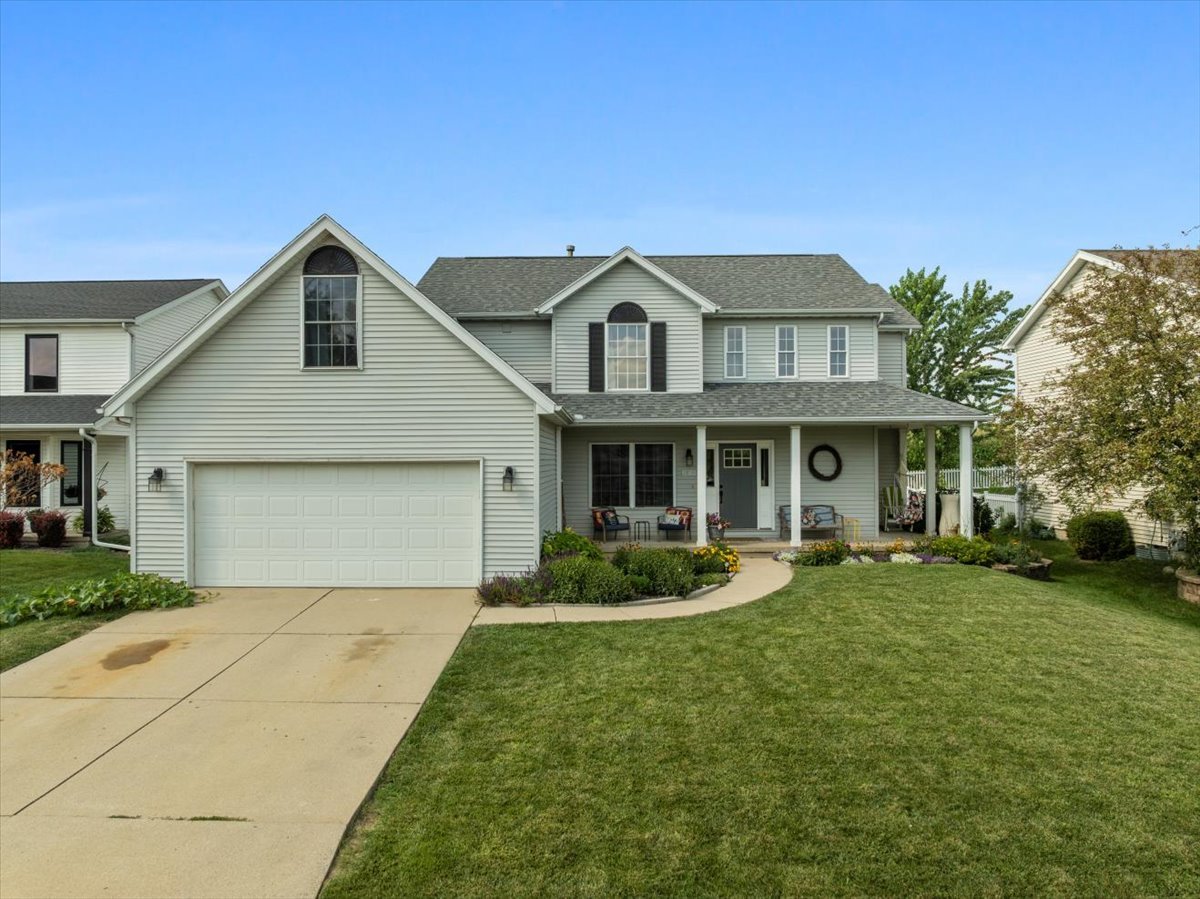 a front view of a house with a yard and porch