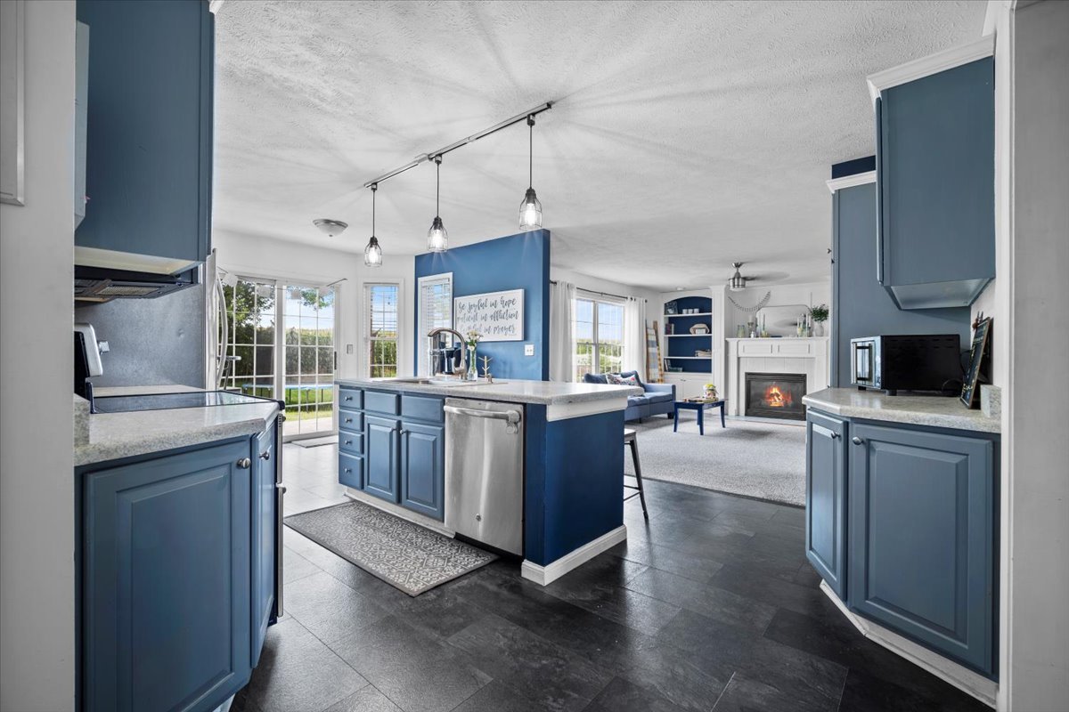 1318 Shannon Road Normal, IL 61761 - Photo 11 of 40 a kitchen with stainless steel appliances granite countertop a stove refrigerator and cabinets