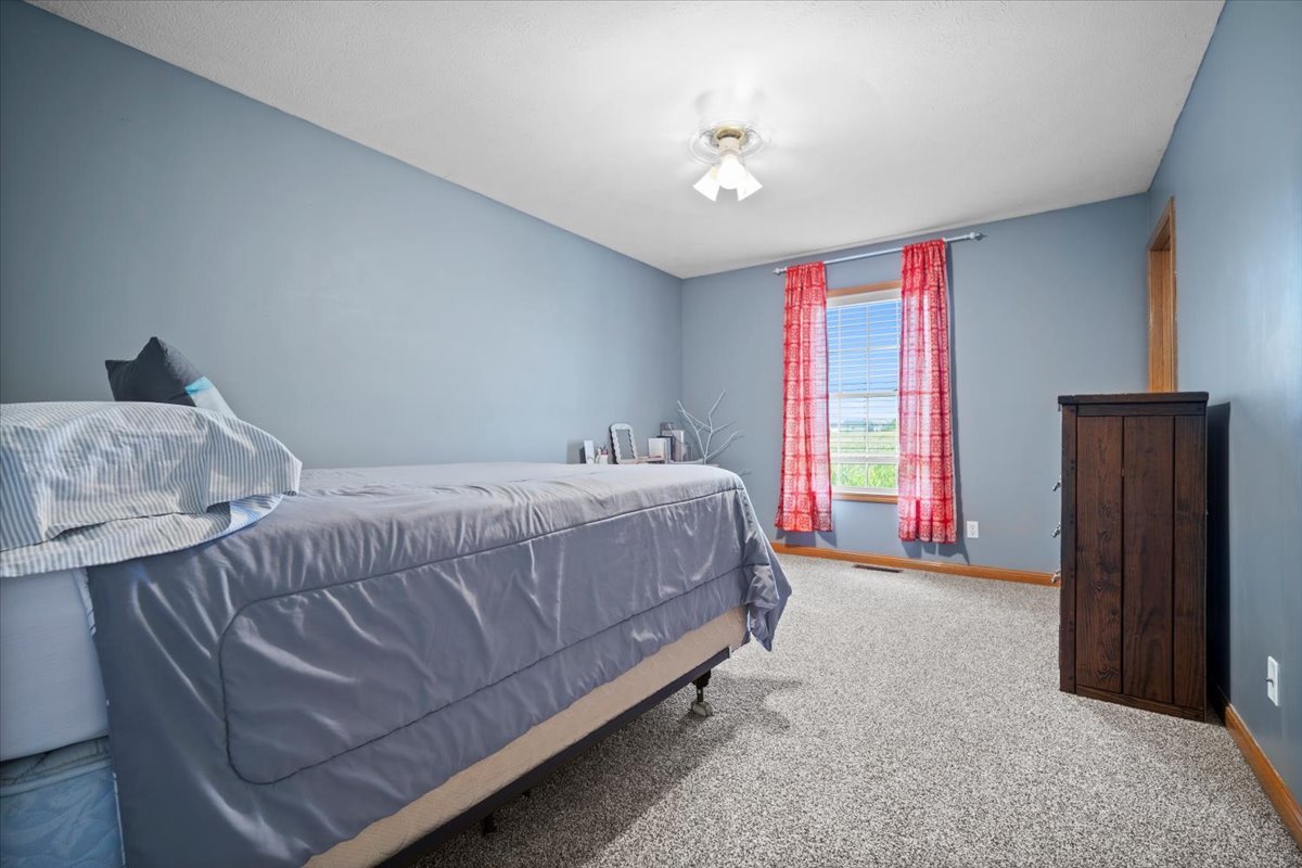 1318 Shannon Road Normal, IL 61761 - Photo 23 of 40 a bedroom with a bed and a chandelier