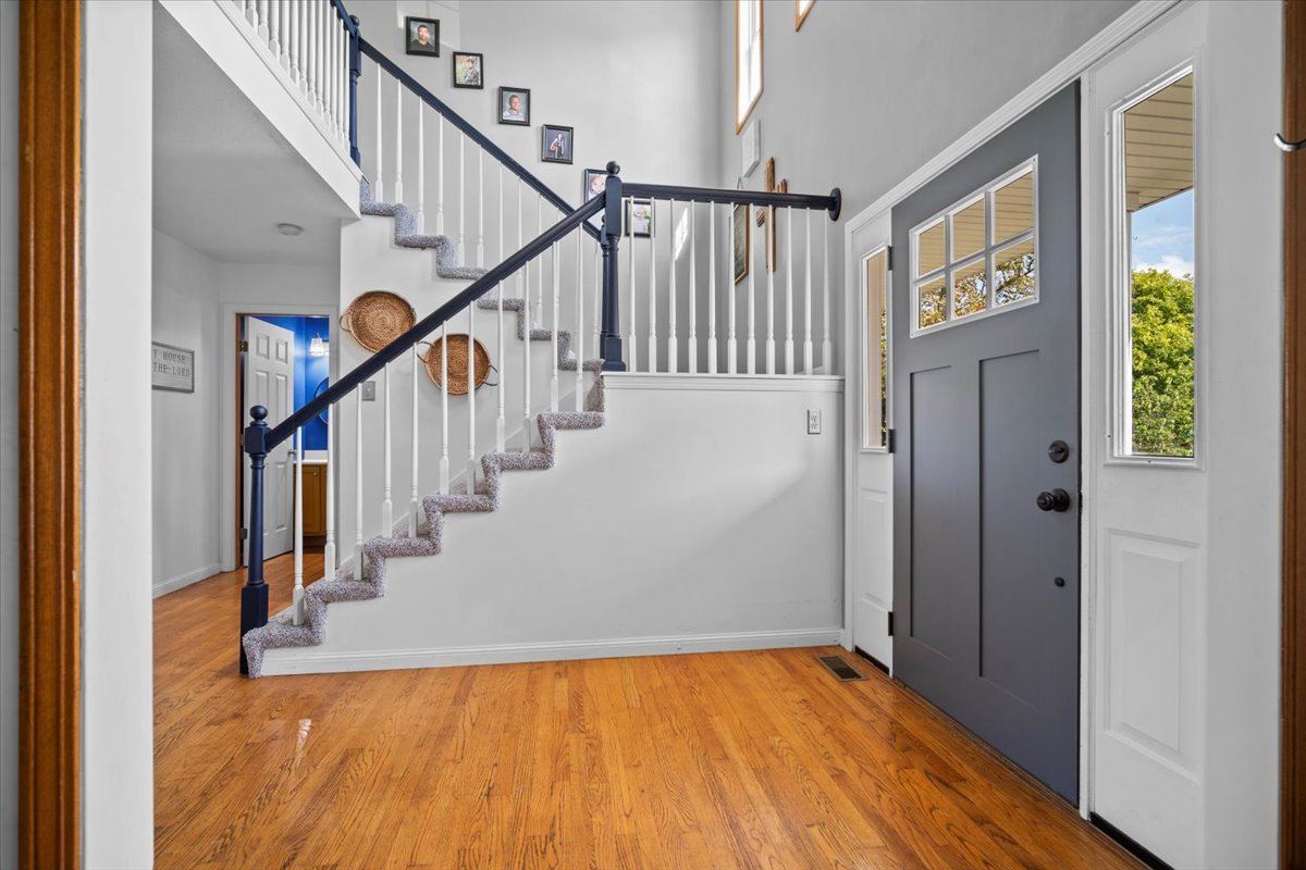 1318 Shannon Road Normal, IL 61761 - Photo 4 of 40 a view of a hallway with wooden floor and staircase