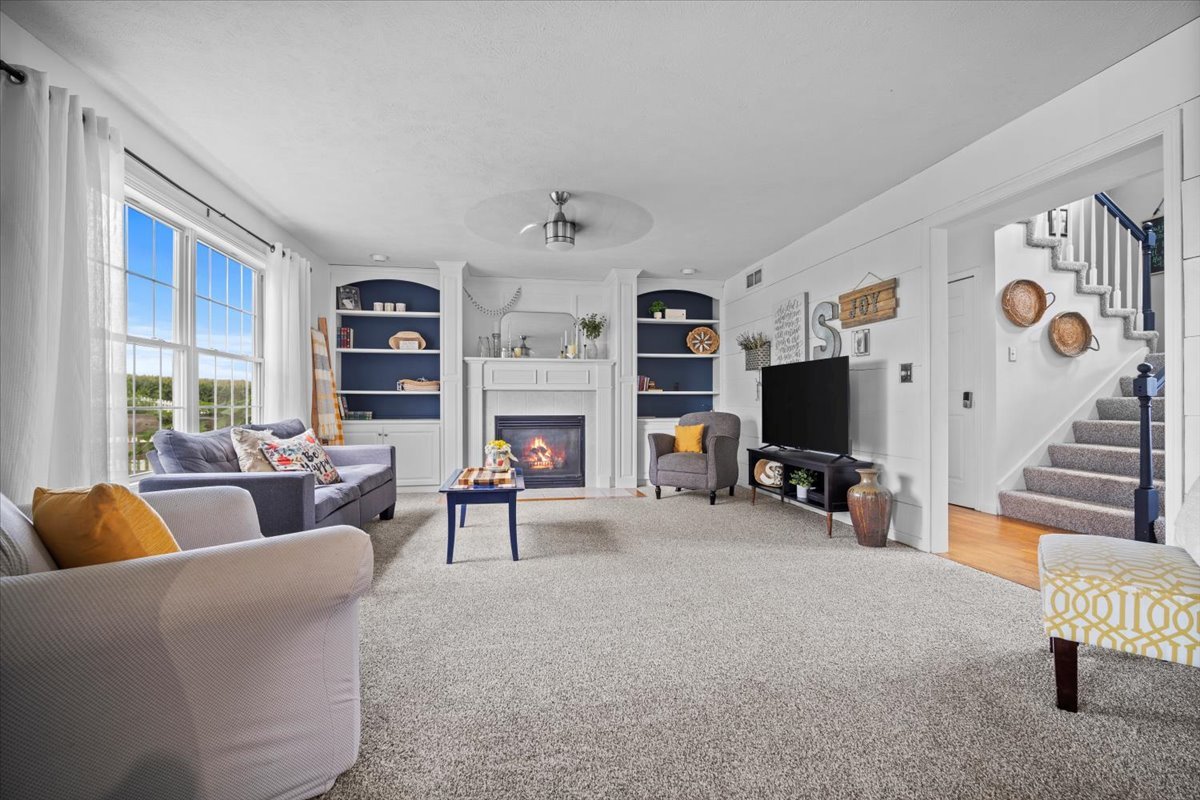 1318 Shannon Road Normal, IL 61761 - Photo 8 of 40 a living room with furniture a fireplace and a flat screen tv