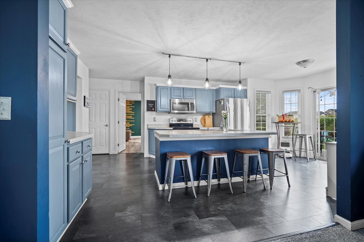 1318 Shannon Road Normal, IL 61761 - Photo 10 of 40 a kitchen with stainless steel appliances a table chairs and a refrigerator