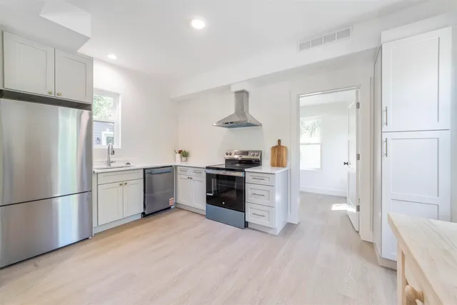 a kitchen with stainless steel appliances granite countertop a stove and a refrigerator