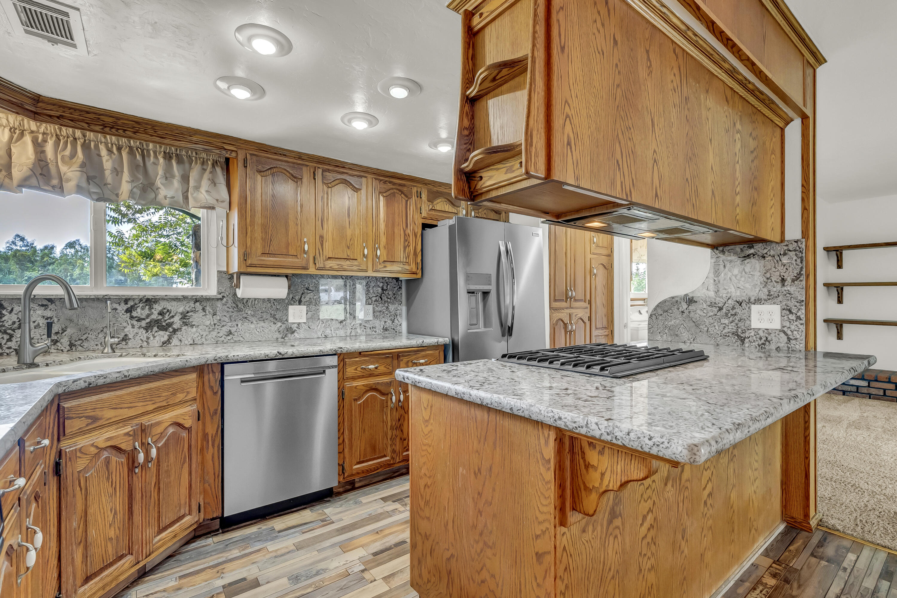 18002 320th Road Springville, CA 93265 - Photo 27 of 56 a kitchen with stainless steel appliances granite countertop a sink a stove and a wooden cabinets