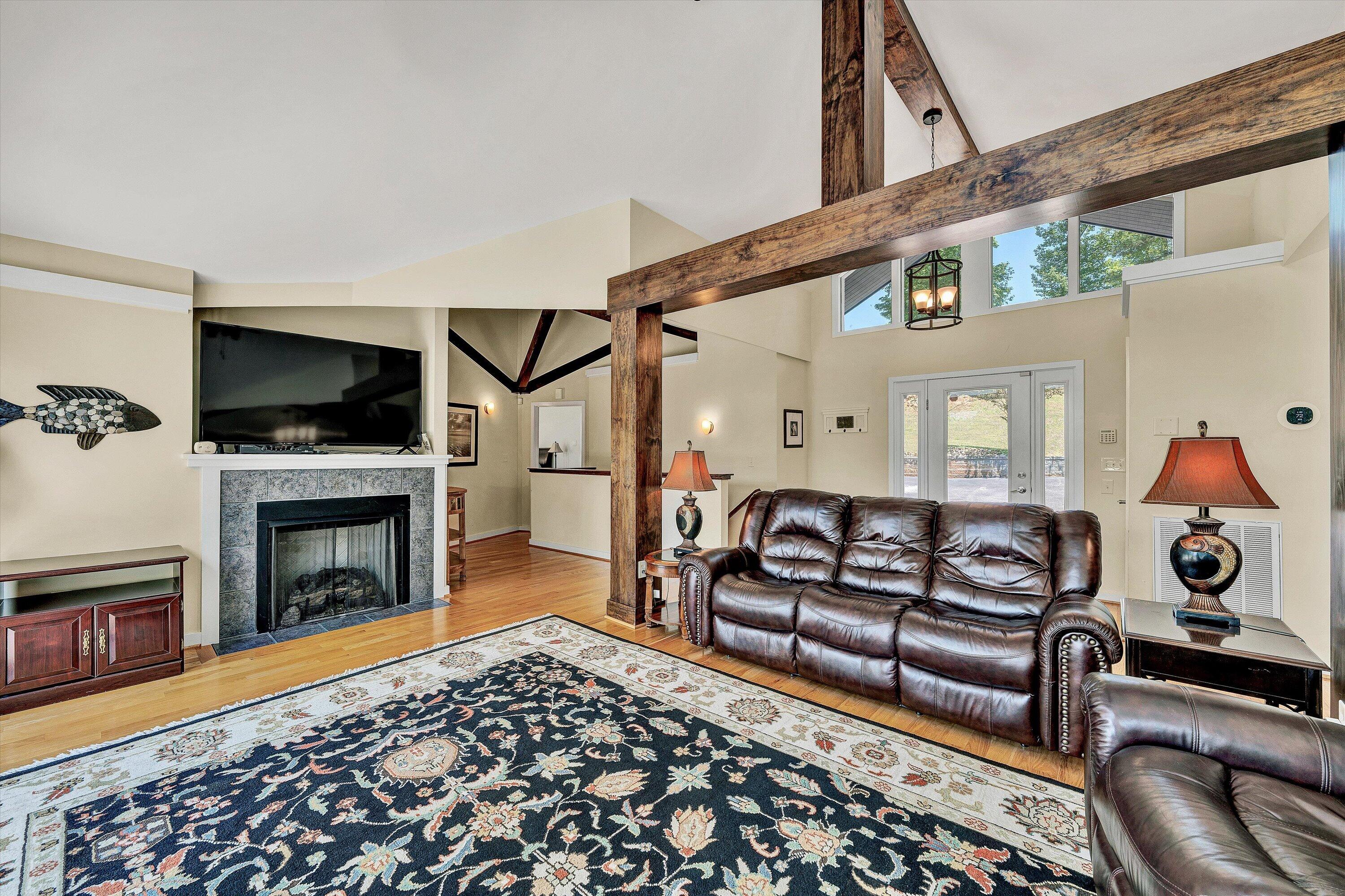 207 Winding Way Union Hall, VA 24176 - Photo 10 of 60 a living room with furniture a fireplace and a flat screen tv