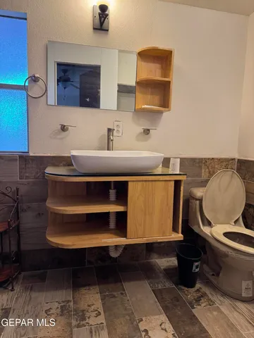 a bathroom with a sink toilet and mirror