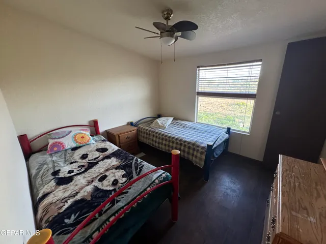 a bedroom with two beds and a chandelier