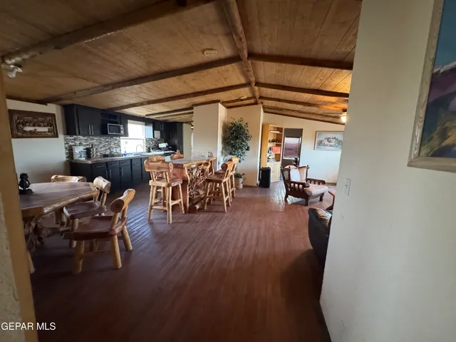 a dining room with furniture a chandelier and wooden floor