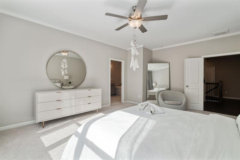 20006 Windalier Way Roswell, GA 30076 - Photo 25 of 58 a bedroom with a bed and a chandelier