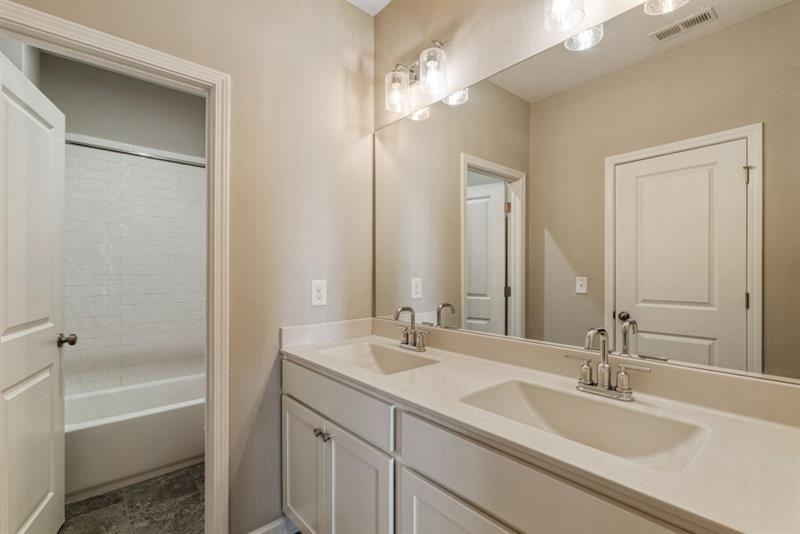 20006 Windalier Way Roswell, GA 30076 - Photo 30 of 58 a bathroom with a tub a sink and mirror