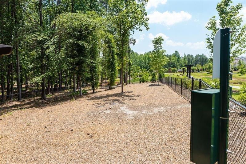 20006 Windalier Way Roswell, GA 30076 - Photo 49 of 58 a view of a road with a bench in the patio