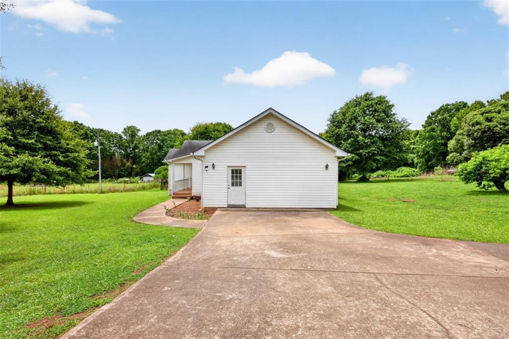 602 Pendergrass Road Winder, GA 30680 - Photo 41 of 44 a view of a house with yard and a garden