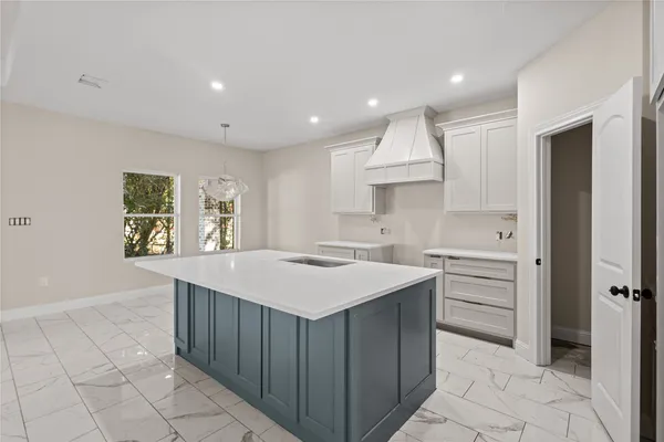 a kitchen with a sink and cabinets