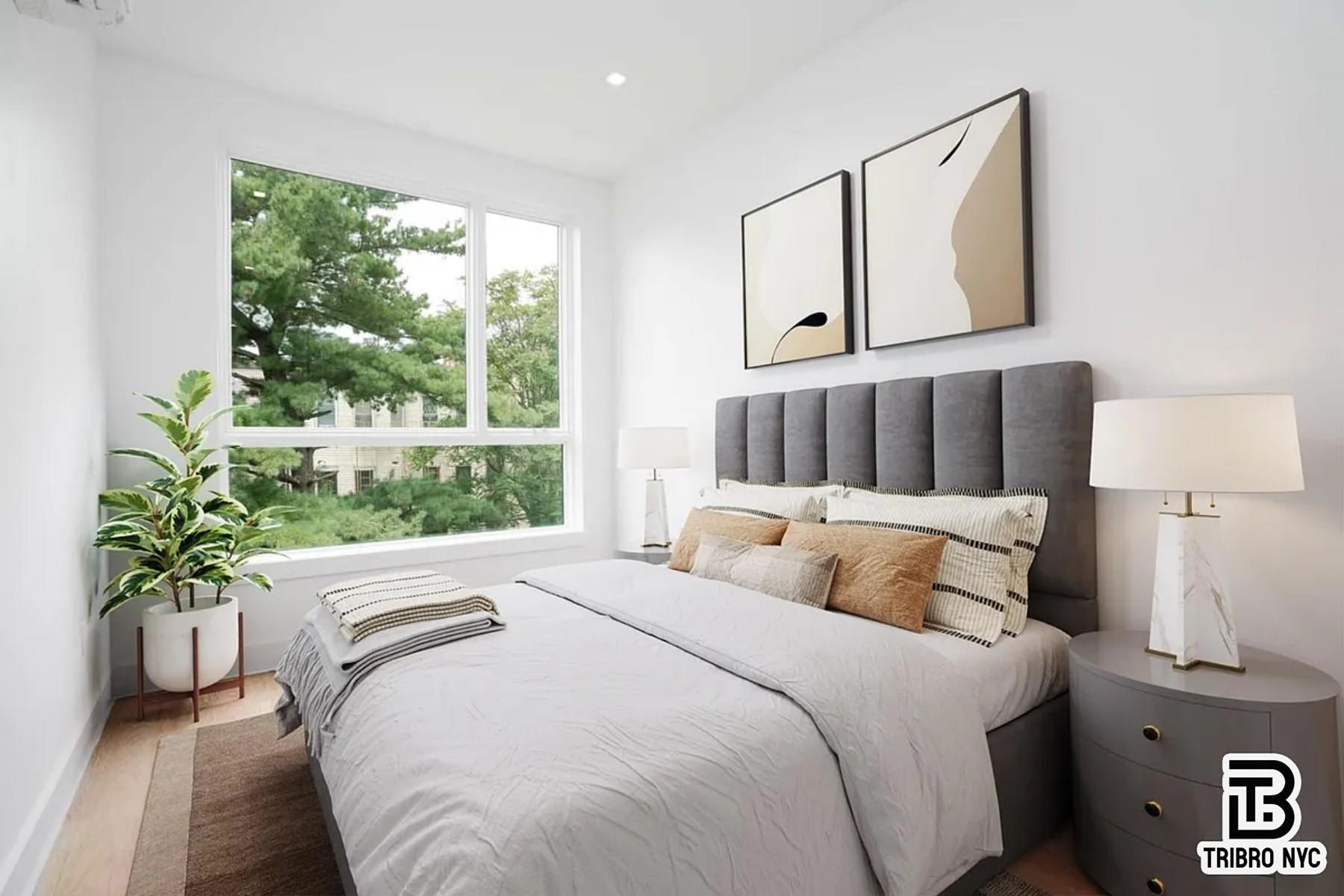 1493 Dekalb Avenue, Unit 2F Brooklyn, NY 11237 - Photo 3 of 6 a bedroom with a large bed and a potted plant