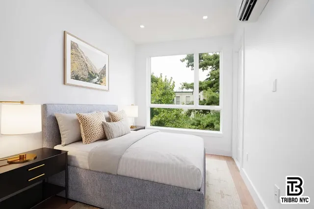 a bed room with a bed and a large window