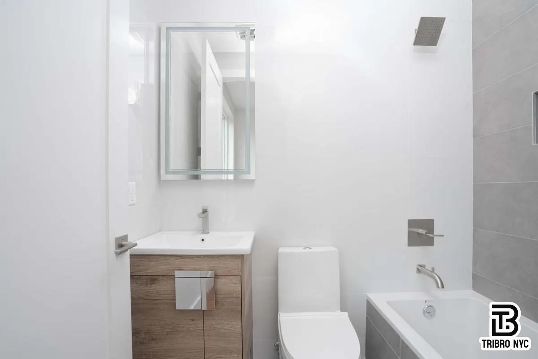 1493 Dekalb Avenue, Unit 2F Brooklyn, NY 11237 - Photo 6 of 6 a bathroom with a toilet sink and mirror