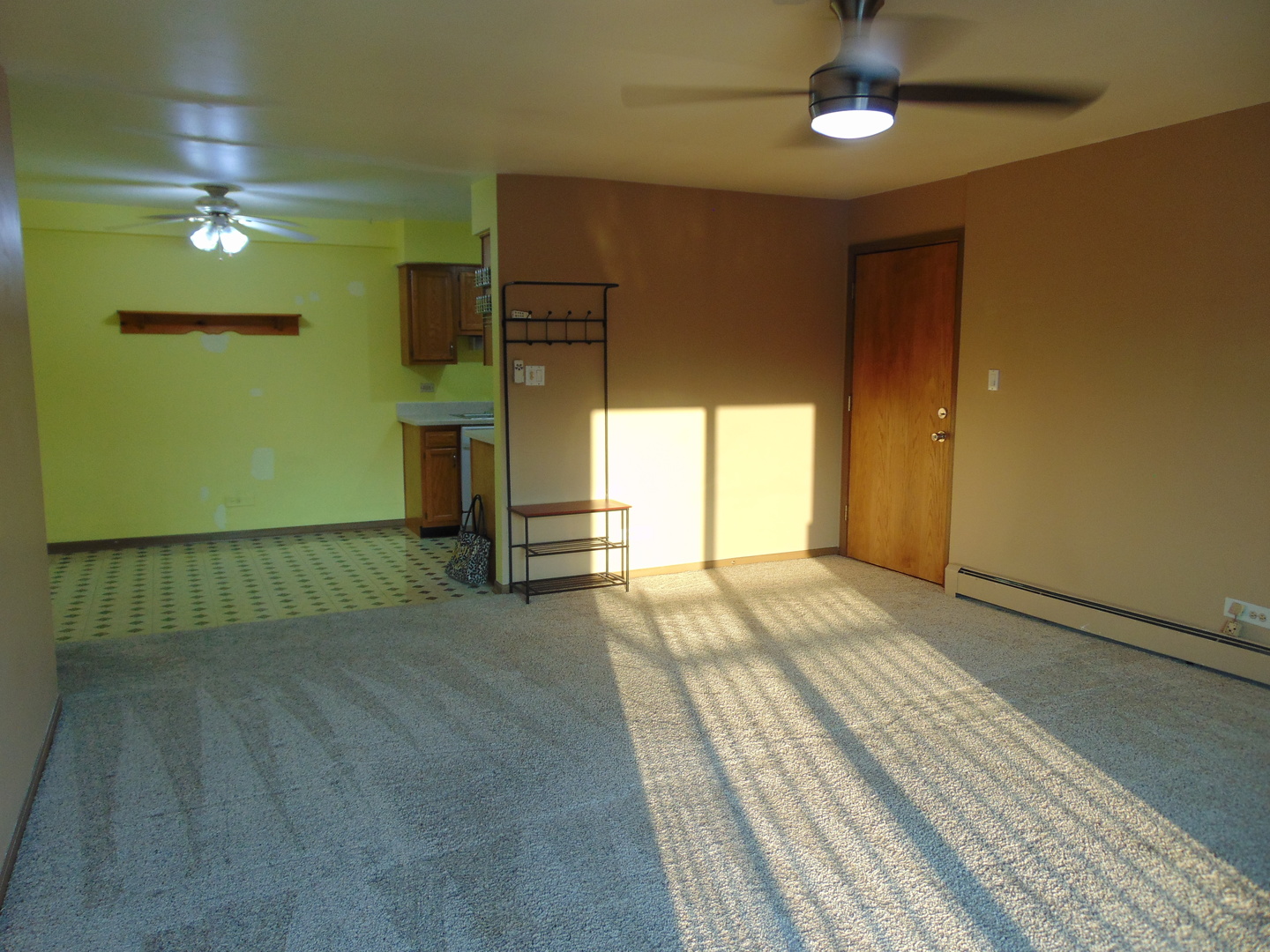 10428 Ridgeland Avenue, Unit 6 Chicago Ridge, IL 60415 - Photo 4 of 11 a view of an empty room with window a ceiling fan and wooden floor